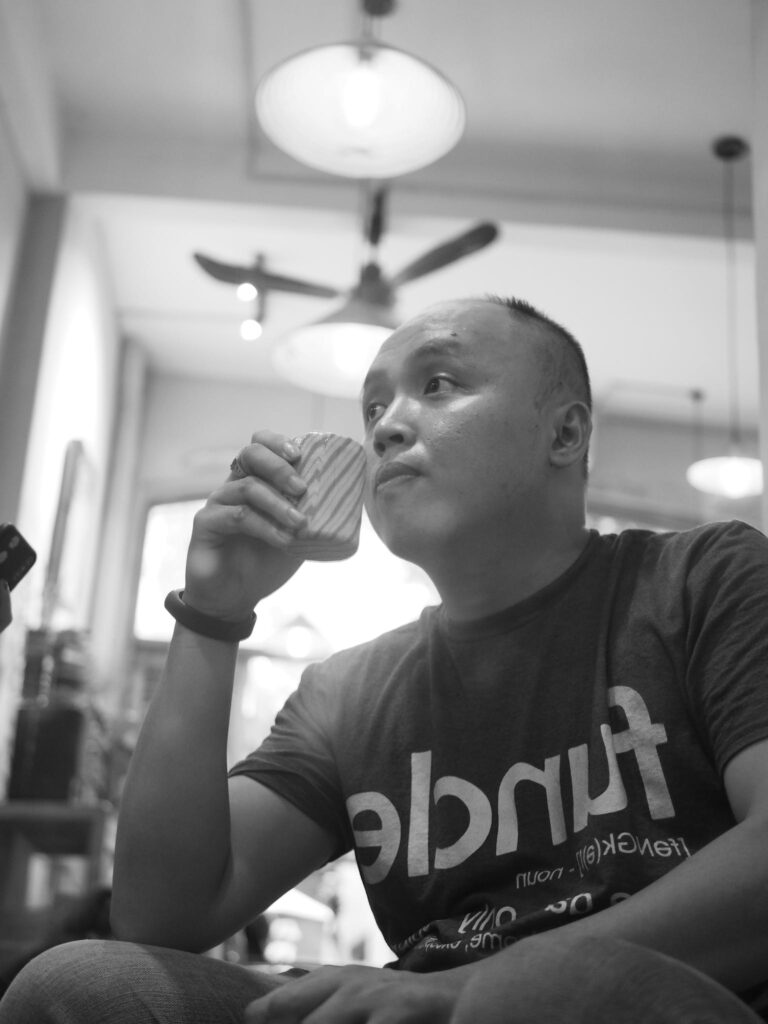 Asian man drinking coffee at home